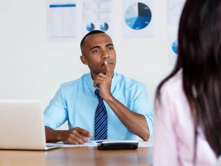 African American businessman listening to an employee at the office of a business company