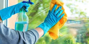 Cleaning window pane with detergent, spring cleaning concept